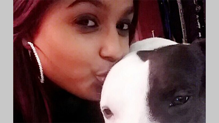 Sushila Jackson kisses her dog on the head