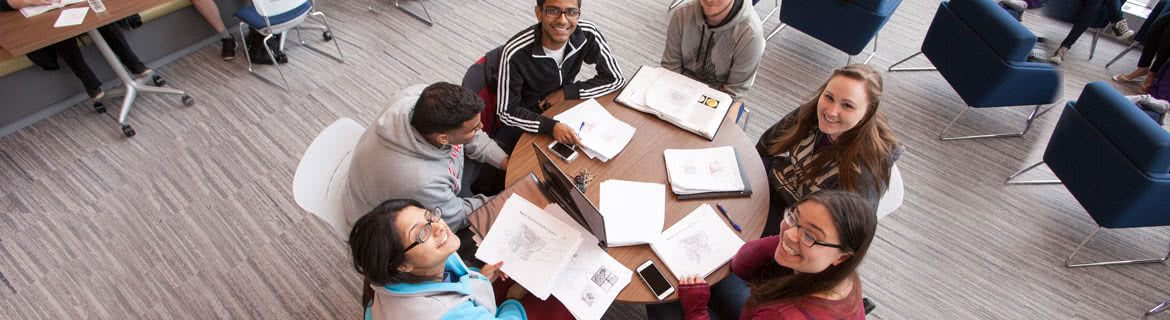 Overhead view of students studying around a table