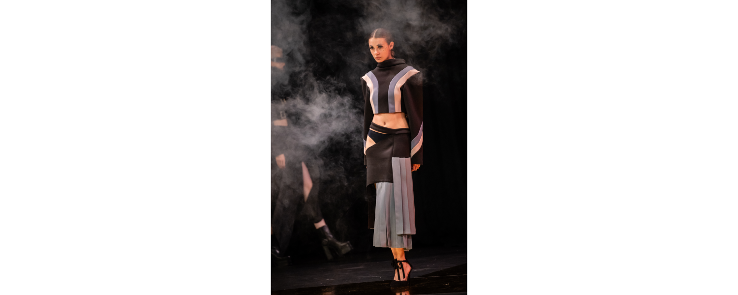 Model wearing a Harper College Fashion Studies student design on the runway at the Fashion & Talents show in Rome.