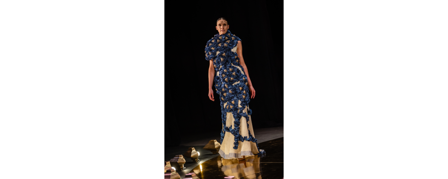 Model wearing a Harper College Fashion Studies student design on the runway at the Fashion & Talents show in Rome.