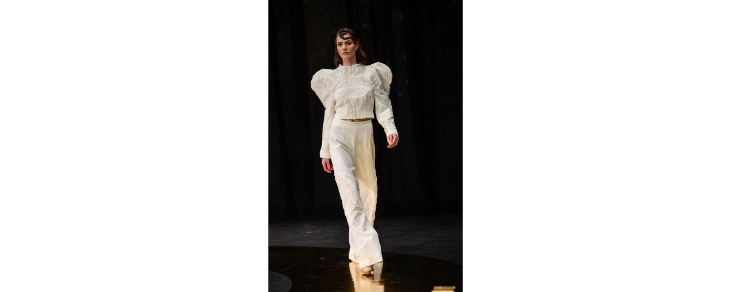 Model wearing a Harper College Fashion Studies student design on the runway at the Fashion & Talents show in Rome.