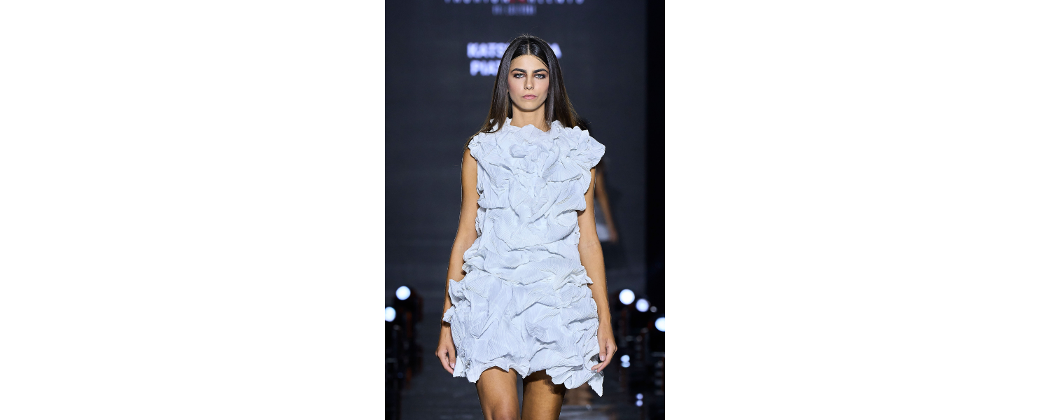 Model wearing a Harper College Fashion Studies student design on the runway at the Fashion & Talents show in Rome.