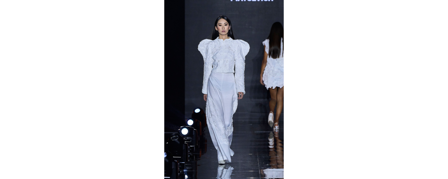 Model wearing a Harper College Fashion Studies student design on the runway at the Fashion & Talents show in Rome.