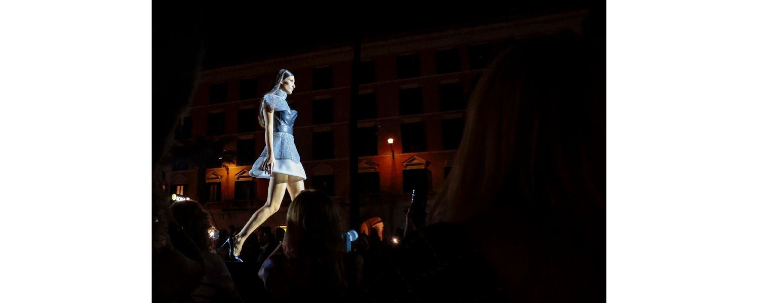 Model wearing a Harper College Fashion Studies student design on the runway at the Fashion & Talents show in Rome.