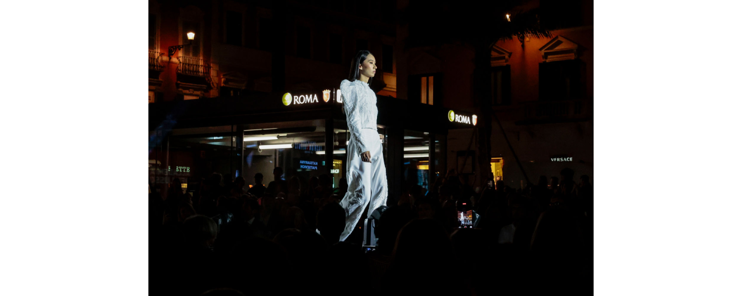 Model wearing a Harper College Fashion Studies student design on the runway at the Fashion & Talents show in Rome.