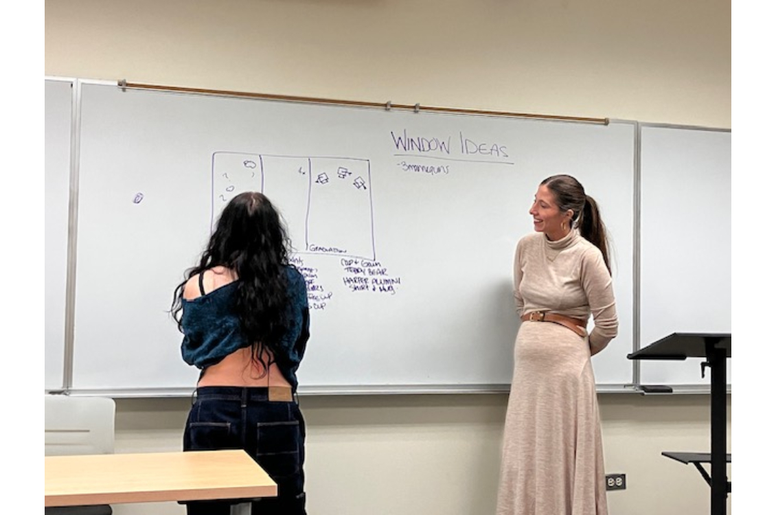 A student using a whiteboard to brainstorm ideas