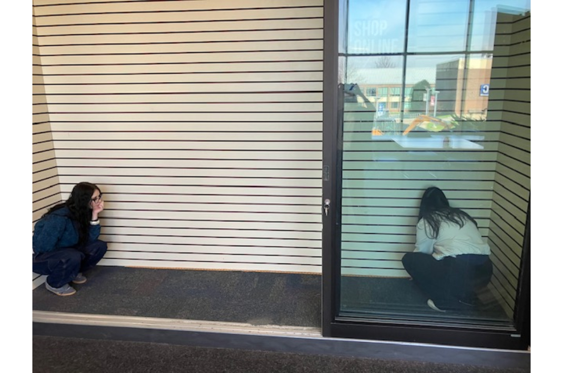 Harper's Bizarre Fashion Club students measuring the available space in the bookstore display window