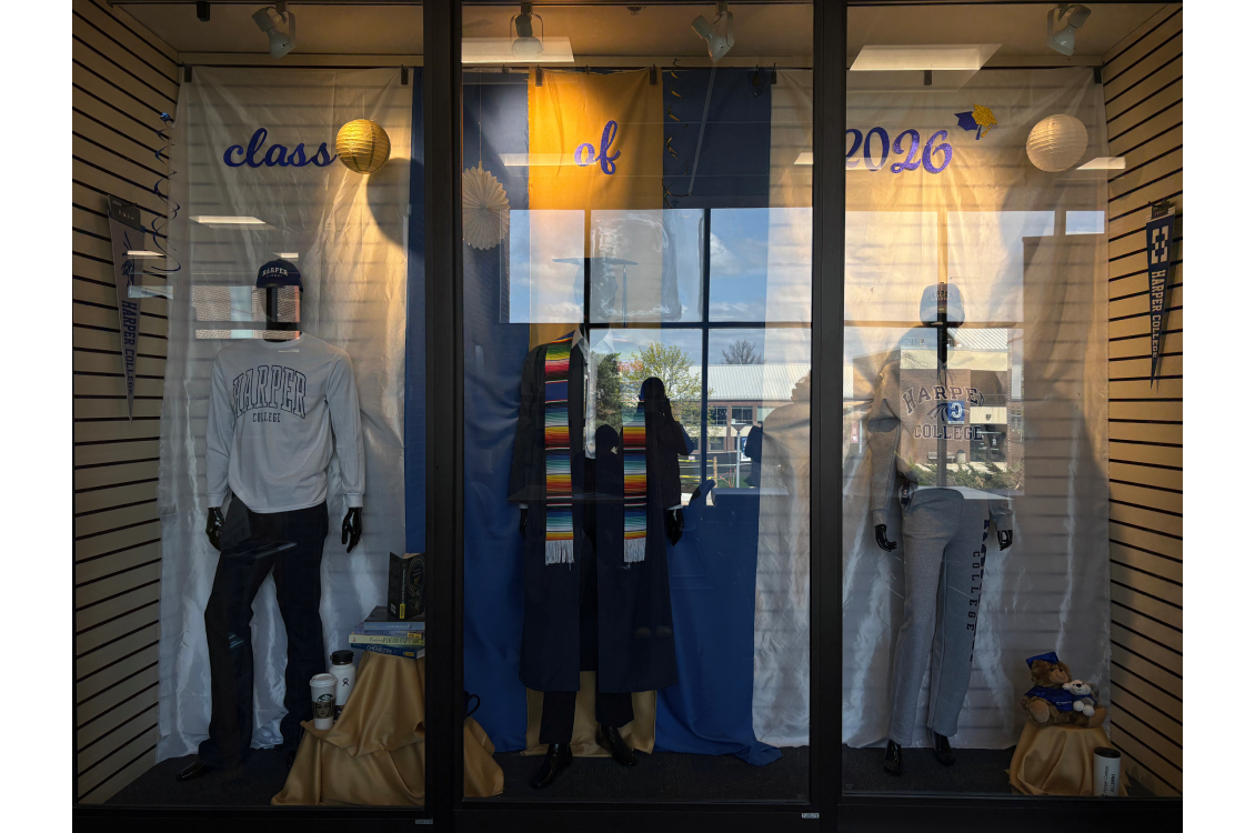 the Harper Bookstore display featuring two mannequins in Harper gear and one in graduation regalia