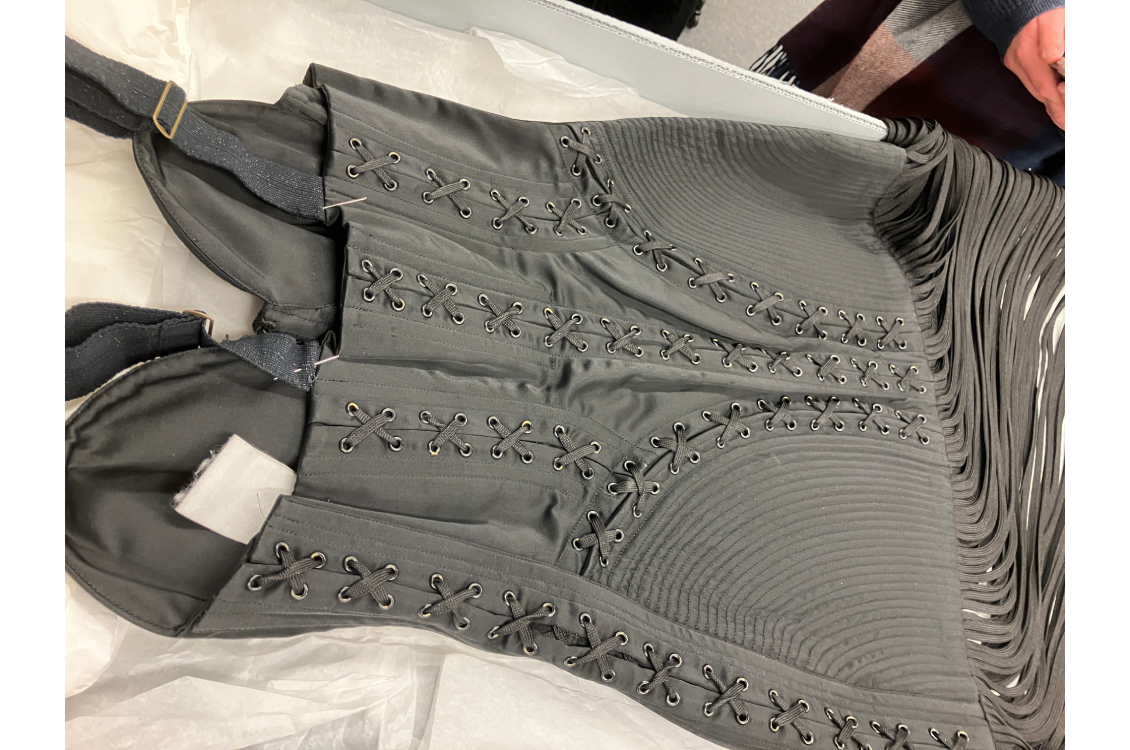 Corset dress by Jean-Paul Gautier. Note that the tassels at the hem are shoelaces. Gautier is famous for creating Madonna’s iconic 1990s cone bra costumes.