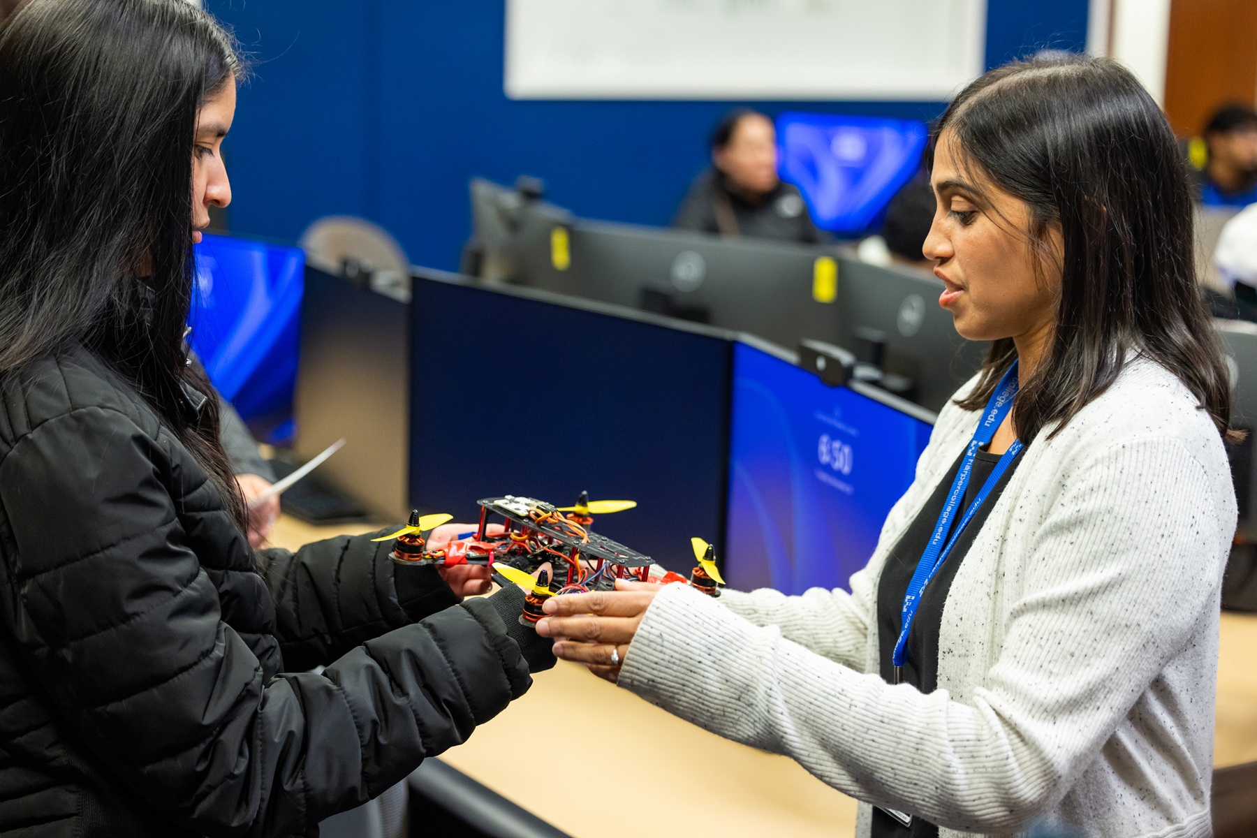 AI certificates Annabel Hasty and a student look at a drone