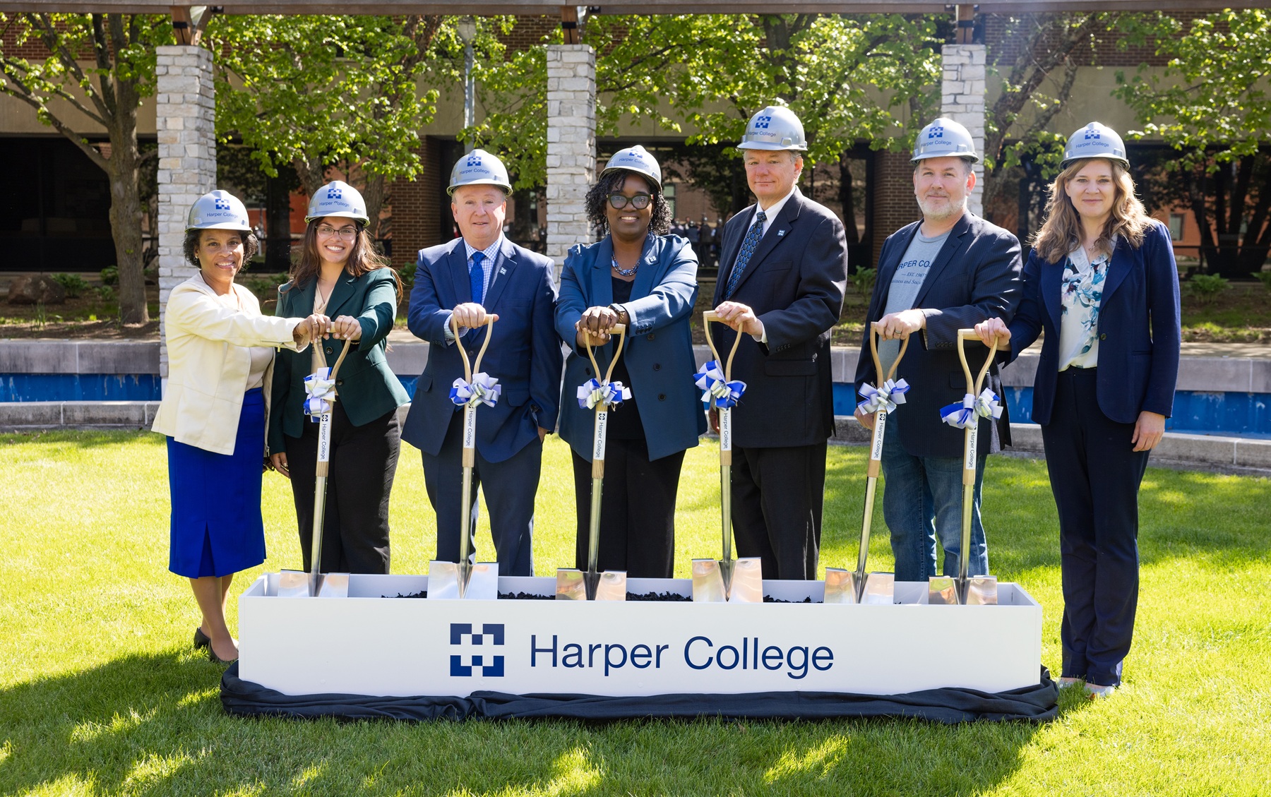 Harper College leaders pose for a groundbreaking photo to celebrate the beginning of construction on the Business and Social Sciences Building