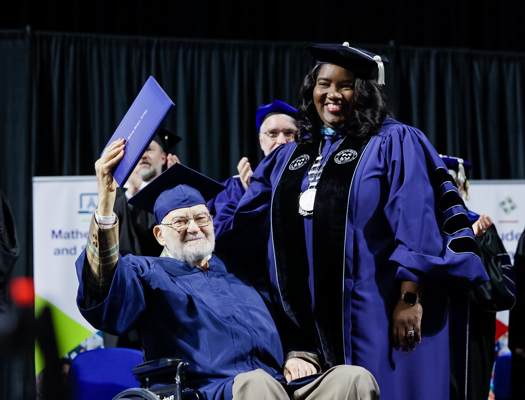 Bernie Bluestein receives an honorary degree from Dr. Avis Proctor at Harper College's 2023 Commencement.