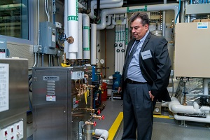 Instructor Jose Vital looks at some equipment in the new BEST Laboratory