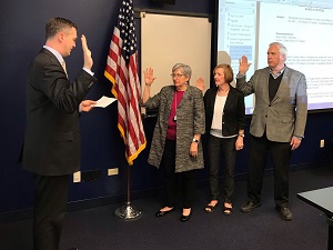 Pat Stack, Nancy Robb and Bill Kelley being sworn in as new board officers