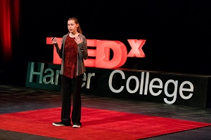 Bree Bogucki speaks on stage at TEDx event