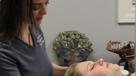 Melissa Armstrong helps a skin care client in her clinic