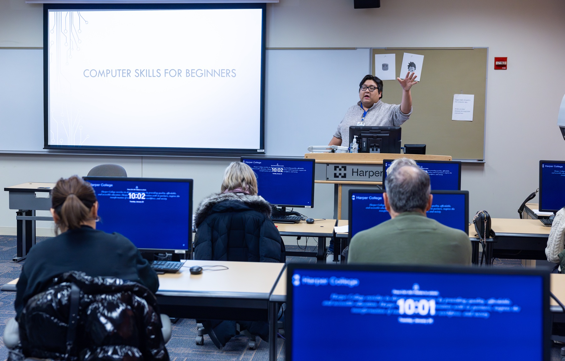 An instructor leads a Community Education computer class for adults.