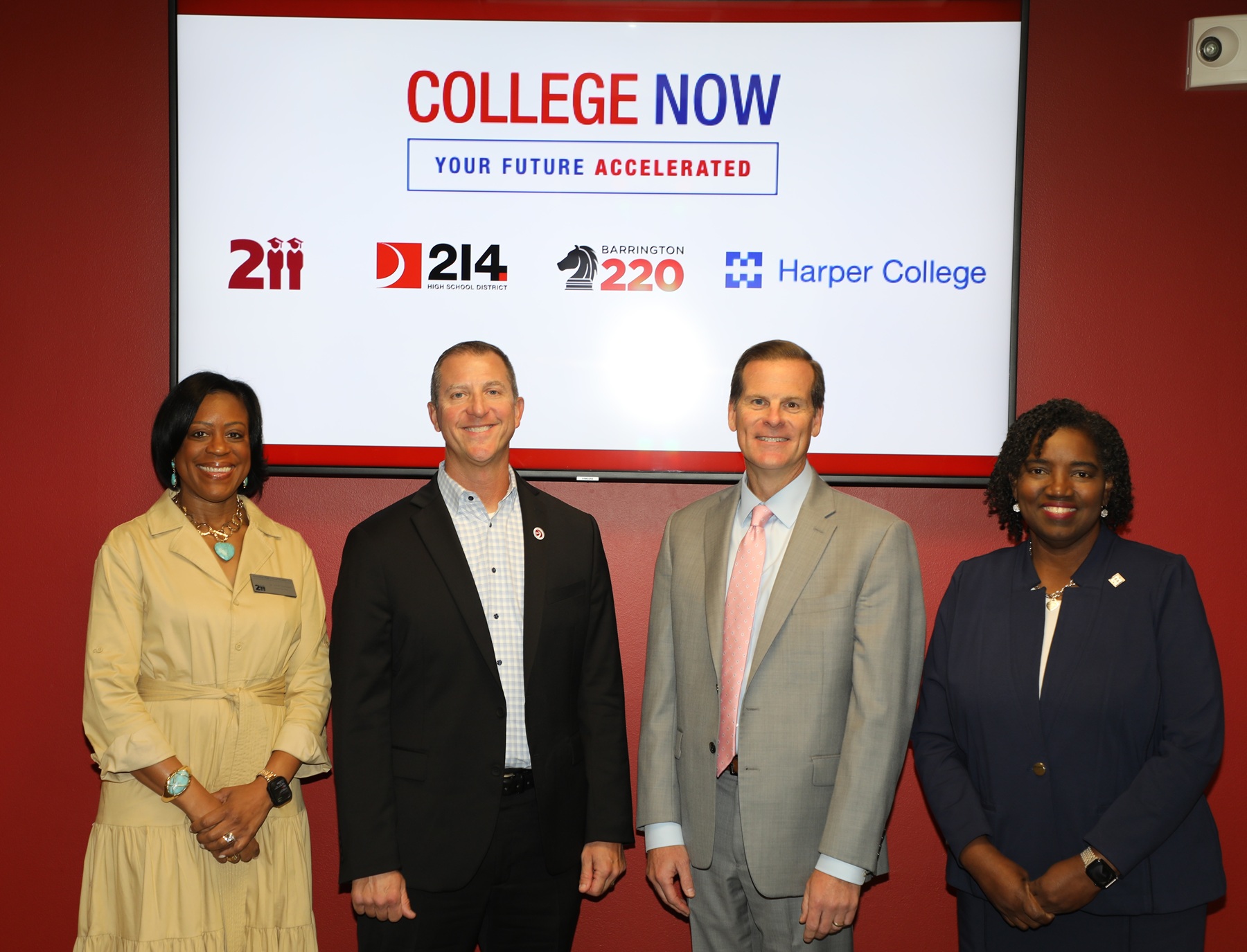Dr. Judith Campbell, superintendent, District 211; Dr. Scott Rowe, superintendent, District 214; Dr. Craig Winkelman, superintendent, Barrington 220; and Dr. Avis Proctor, president, Harper College; stand before a logo for the College Now program.