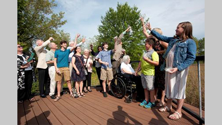 Craig Stettner's family releases milkweed into the Harper College prairie