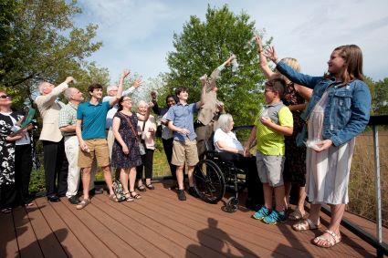 Craig Stettner's family releases milkweed into the Harper College prairie