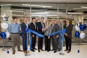 Trustee Diane Hill cuts the ribbon at the library dedication