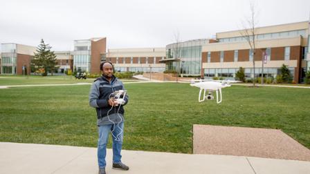 Mukila Maitha flies a drone at Harper College