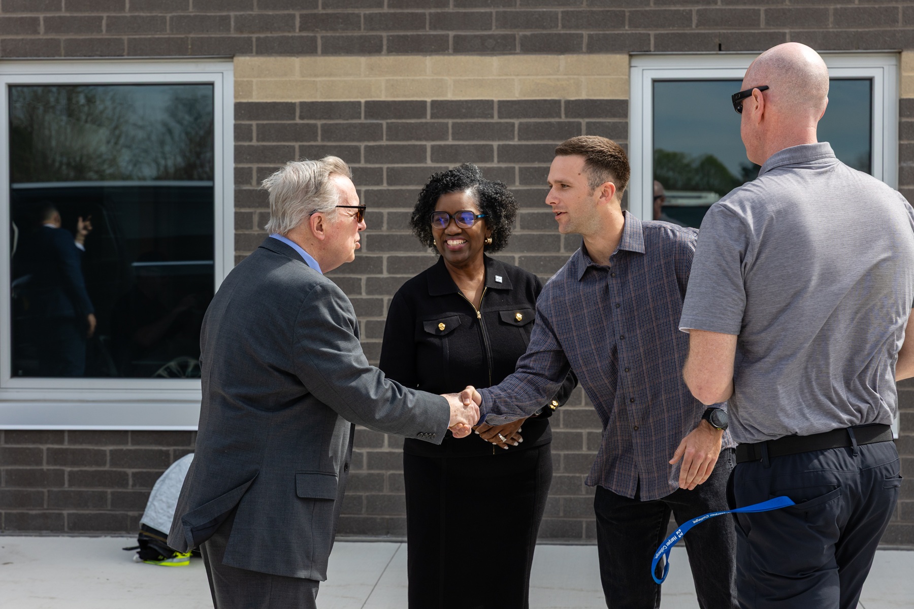 Sen. Dick Durbin shakes the hand of Harper student Trace Holloway as Dr. Avis Proctor and Norm Bemis look on.