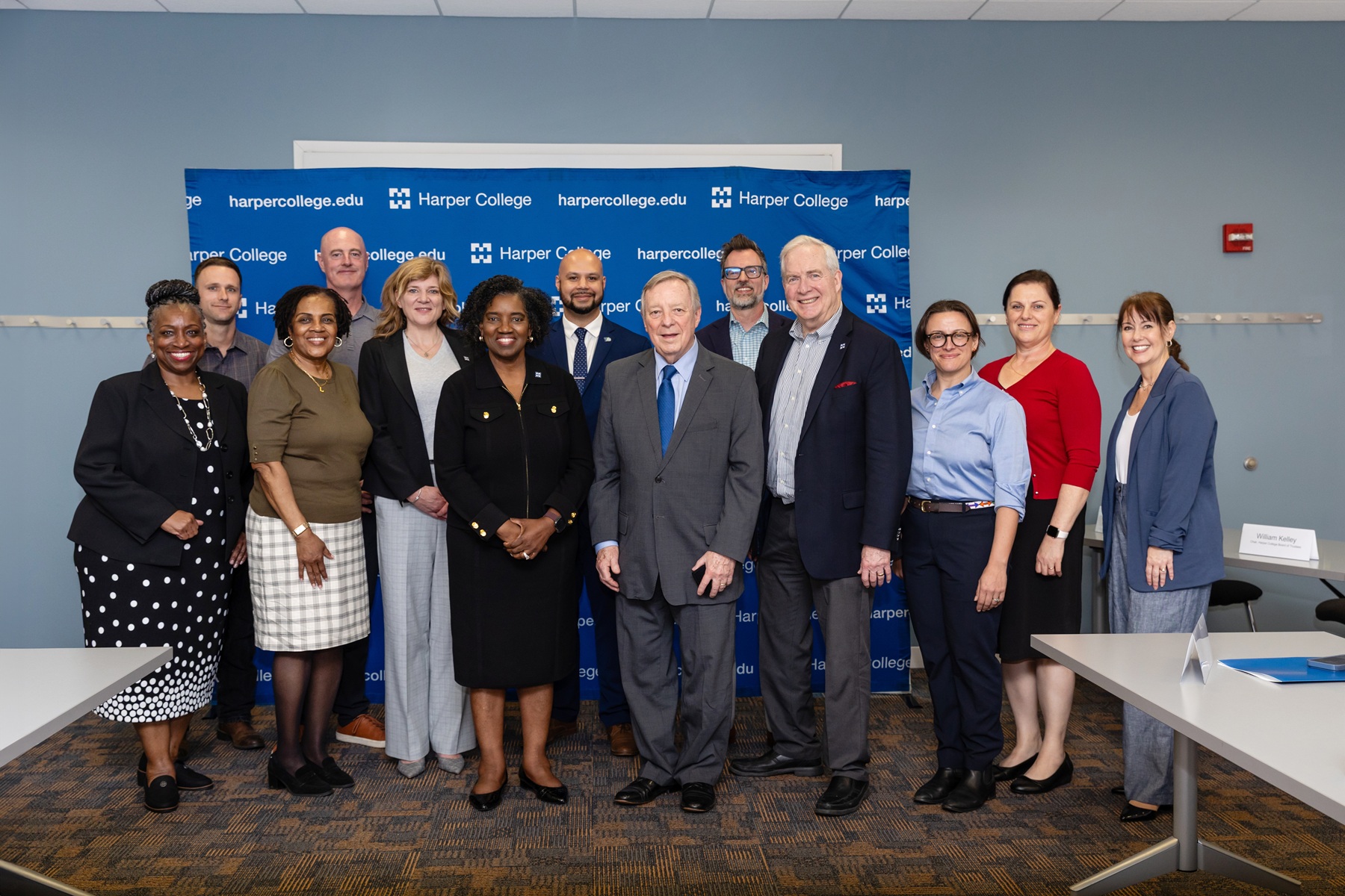 Sen. Dick Durbin stands with Harper College representatives and community leaders in a Harper classroom.