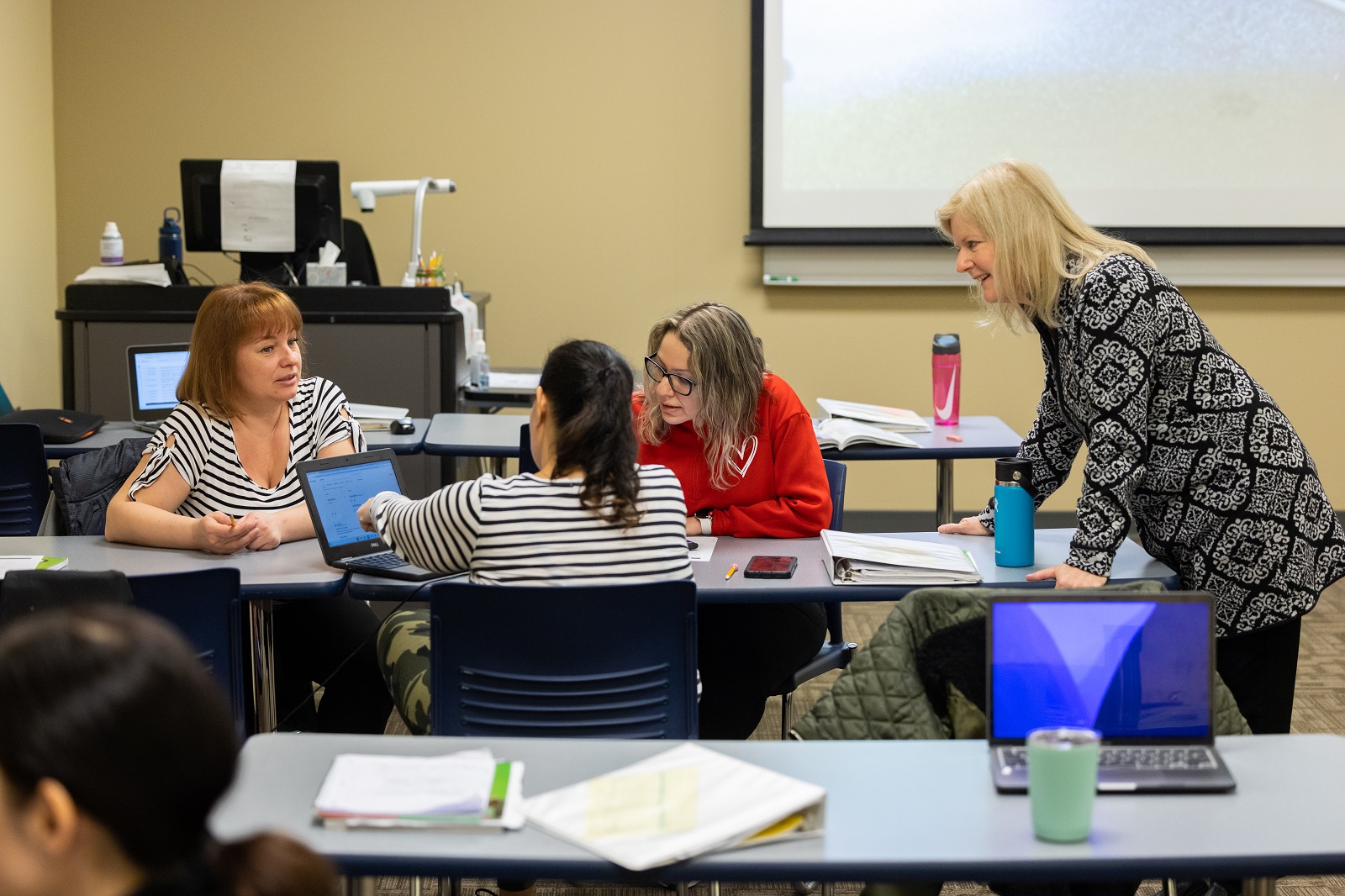 Instructor Betsy Kubota and students interact at the Education Work Center in Hanover Park.