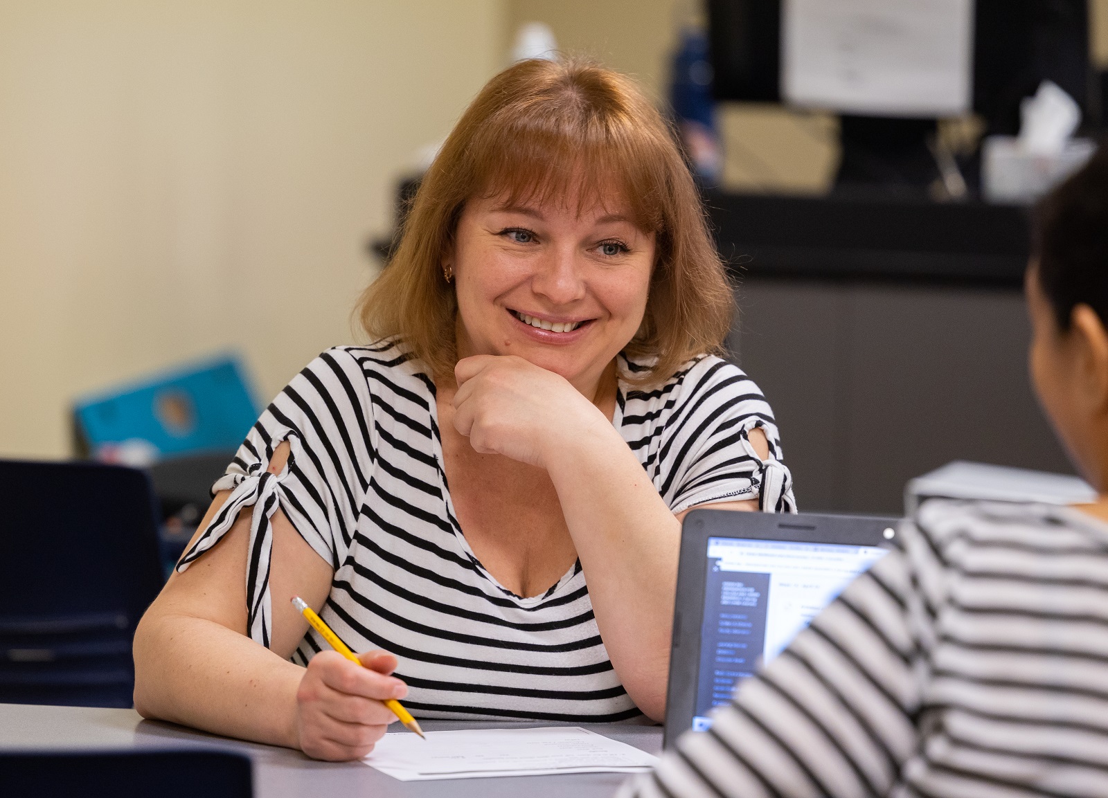 Iryna Dzundza interacts with a fellow student at the Education and Work Center.