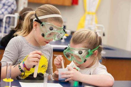 Young students do an experiment at Harper's College and Career Expo