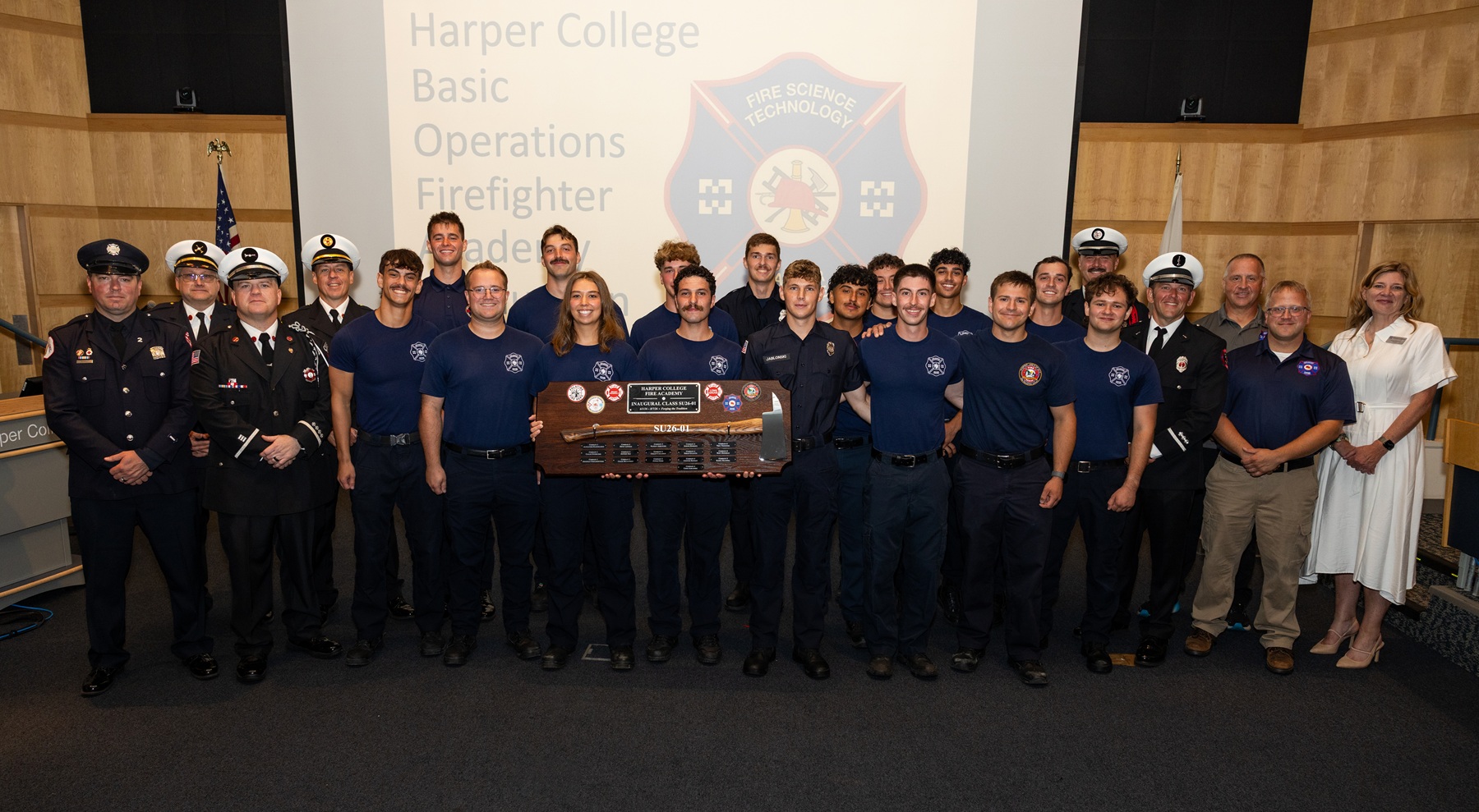 The graduates from Harper College's first Fire Academy at the new Emergency Services Training Center pose for a graduation photo with instructors and Harper's provost