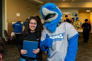 Harper Hawk mascot with a prospective student