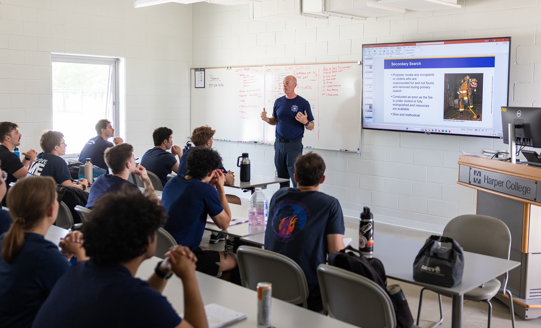Norm Bemis, Fire Science Technology program coordinator, stands in front of a whiteboard while teaching a class in Harper's Fire Academy