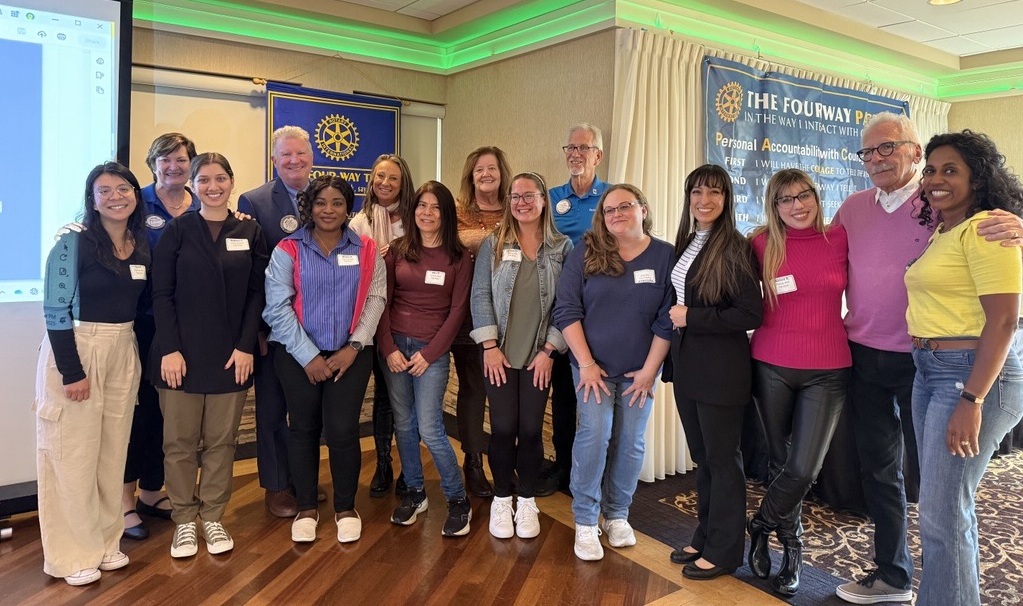 A group of Fishing Well Scholarship recipients poses for a photo with members of the Rotary Club of Schaumburg-Hoffman Estates