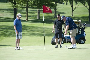 Golfers putt at the Harper College Golf Open