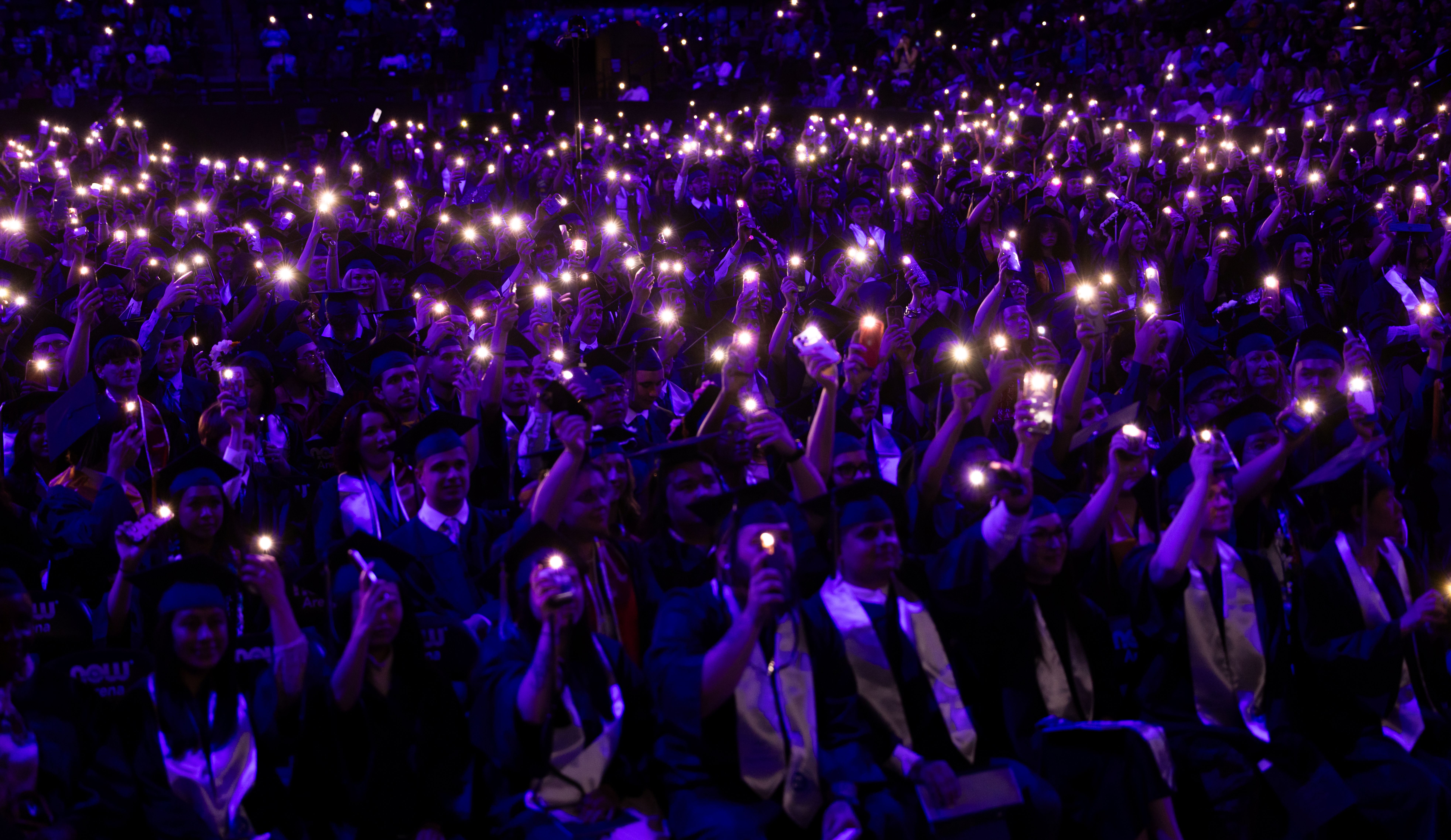 Harper College graduates turn on their cell phone lights