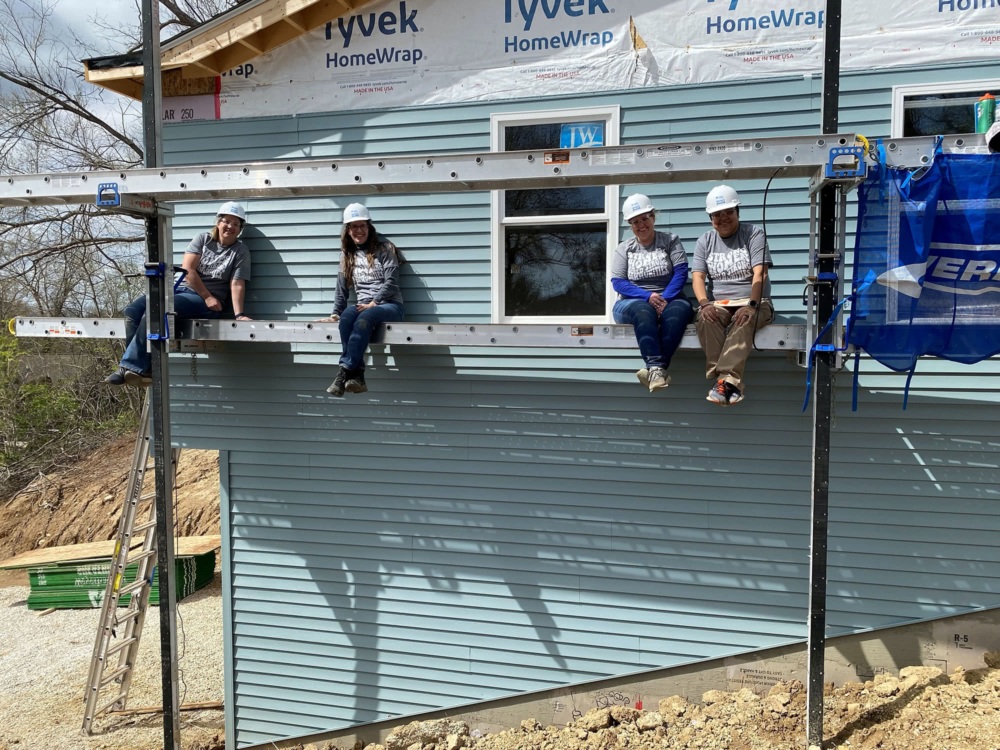 Harper women on scaffolding at Habitat for Humanity house