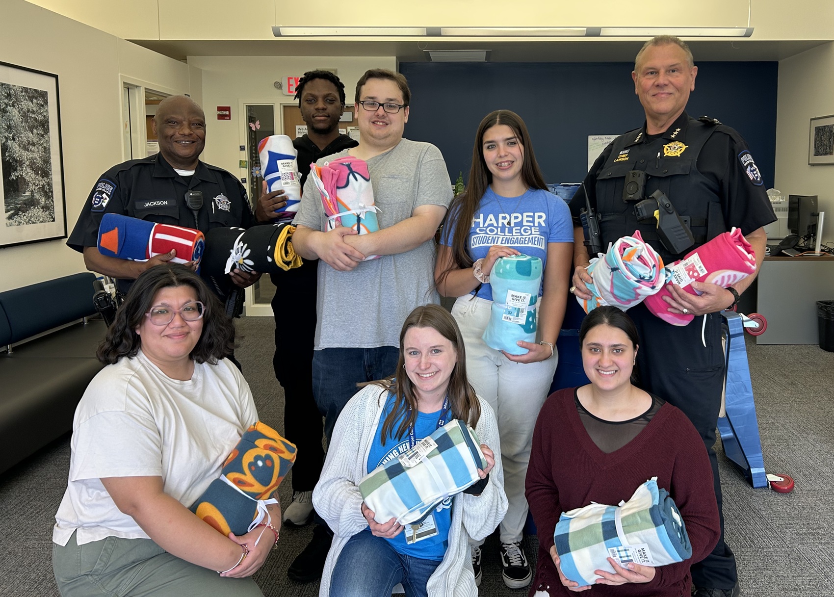 Harper College Police Department Blanket Donation Members of the Harper College Police Department and Hawks Care staff stand with blankets donated by the department