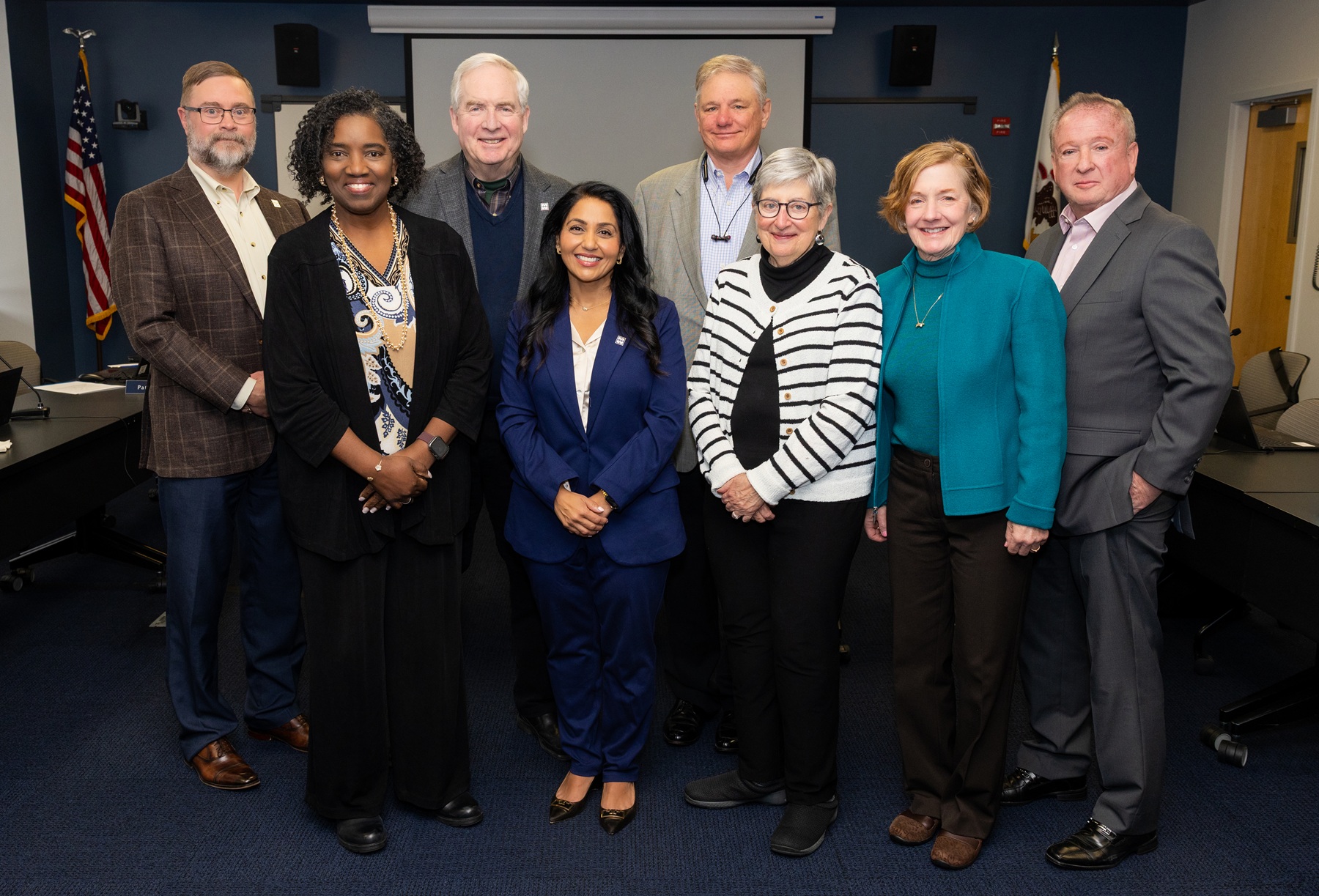 Harper Trustees Eric Knox, Bill Kelley, James Meyer, Pat Stack, Nancy Robb and Walt Mundt stand with newly appointed trustee Bijal Chaturvedi and Dr. Avis Proctor, president of Harper College