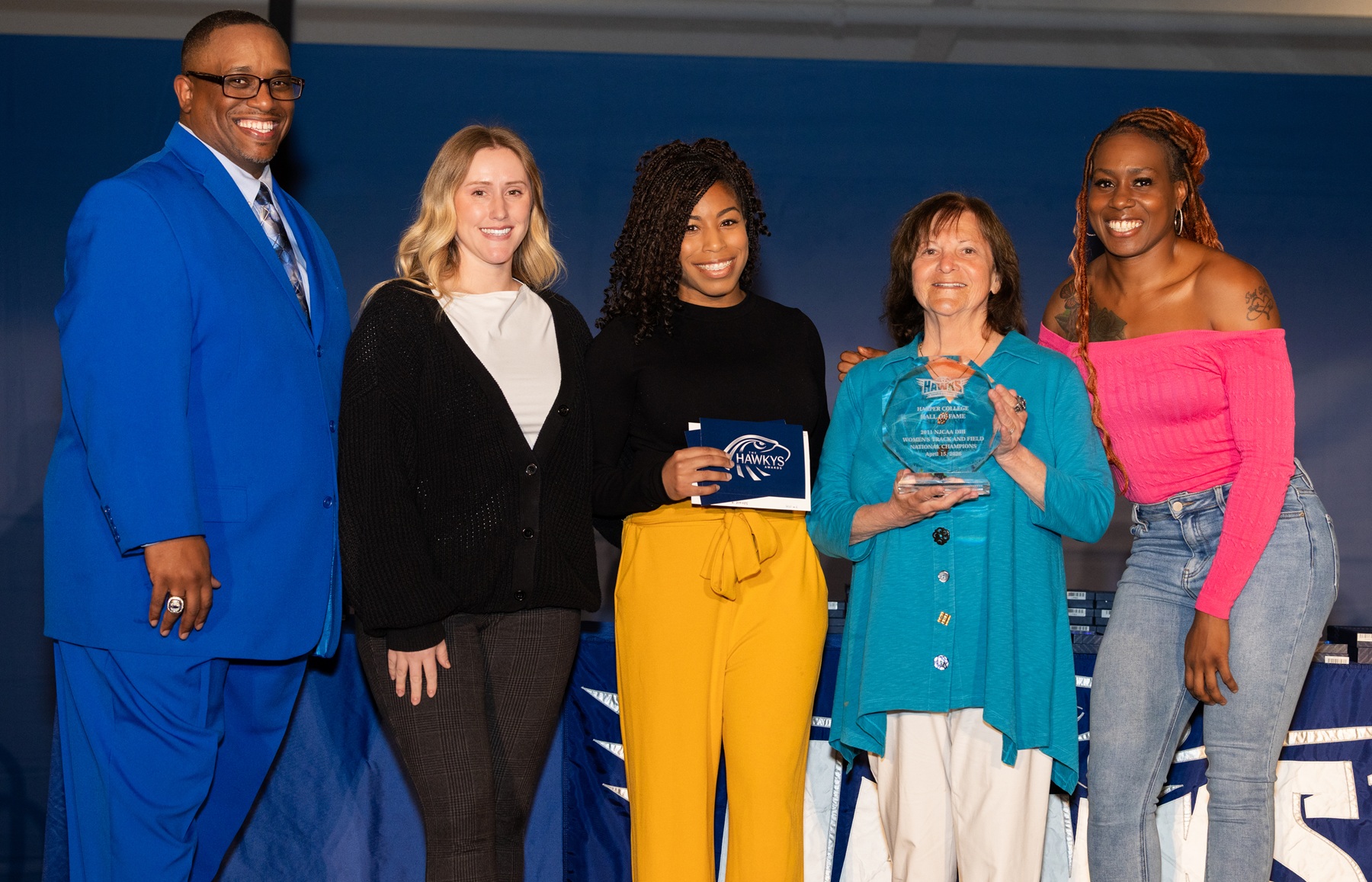 Members of the 2011 Women's Track and Field team stand with Dr. Cedric Brown and Coach Renee Zellner after being inducted into the Harper Athletics Hall of Fame.