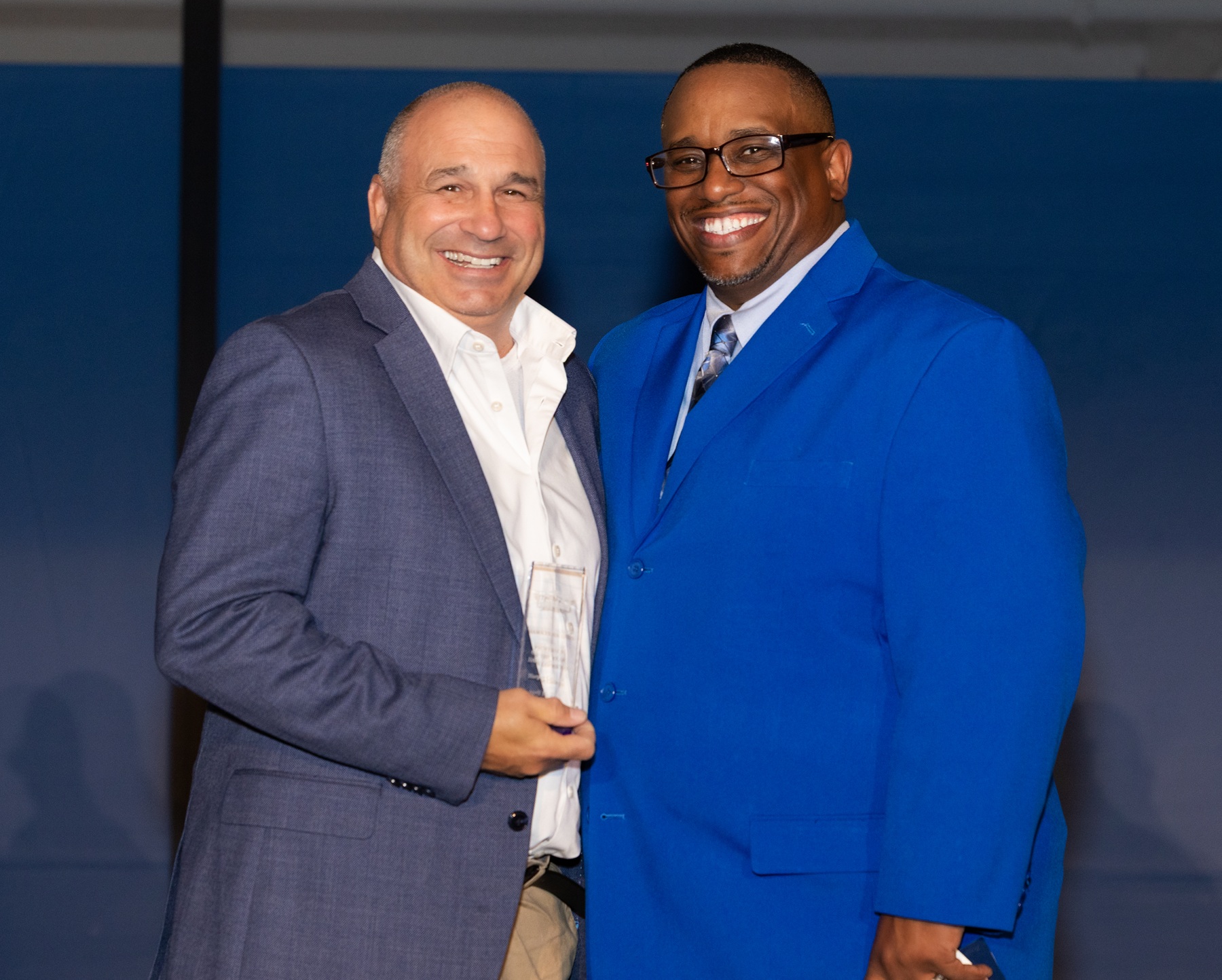 Harper Professor and Wrestling Coach Dan Loprieno stands with Dr. Cedric Brown.