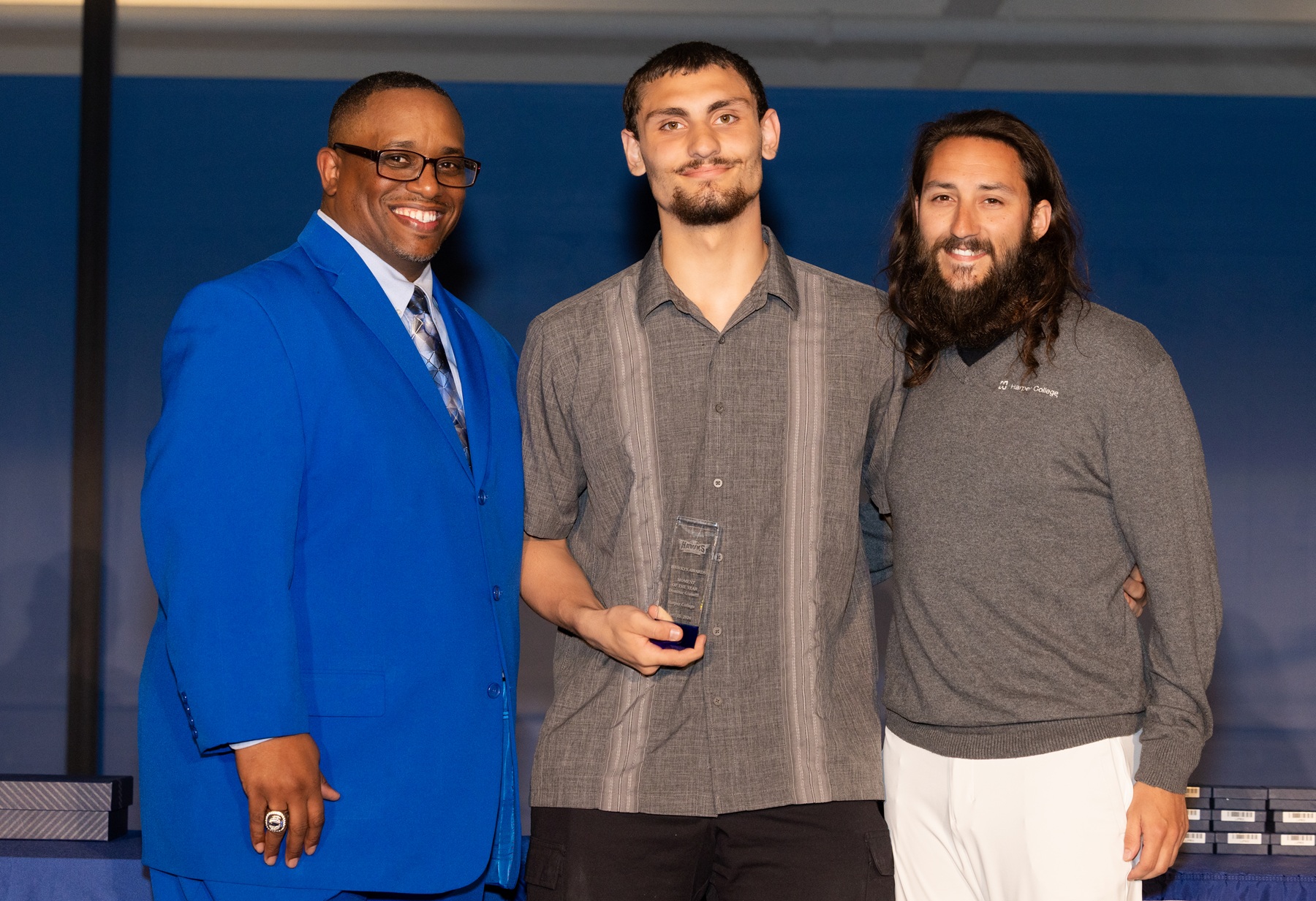 Dominic Giuseffi holds his HAWKYS Award with Dr. Cedric Brown and Assistant Coach John Majerus