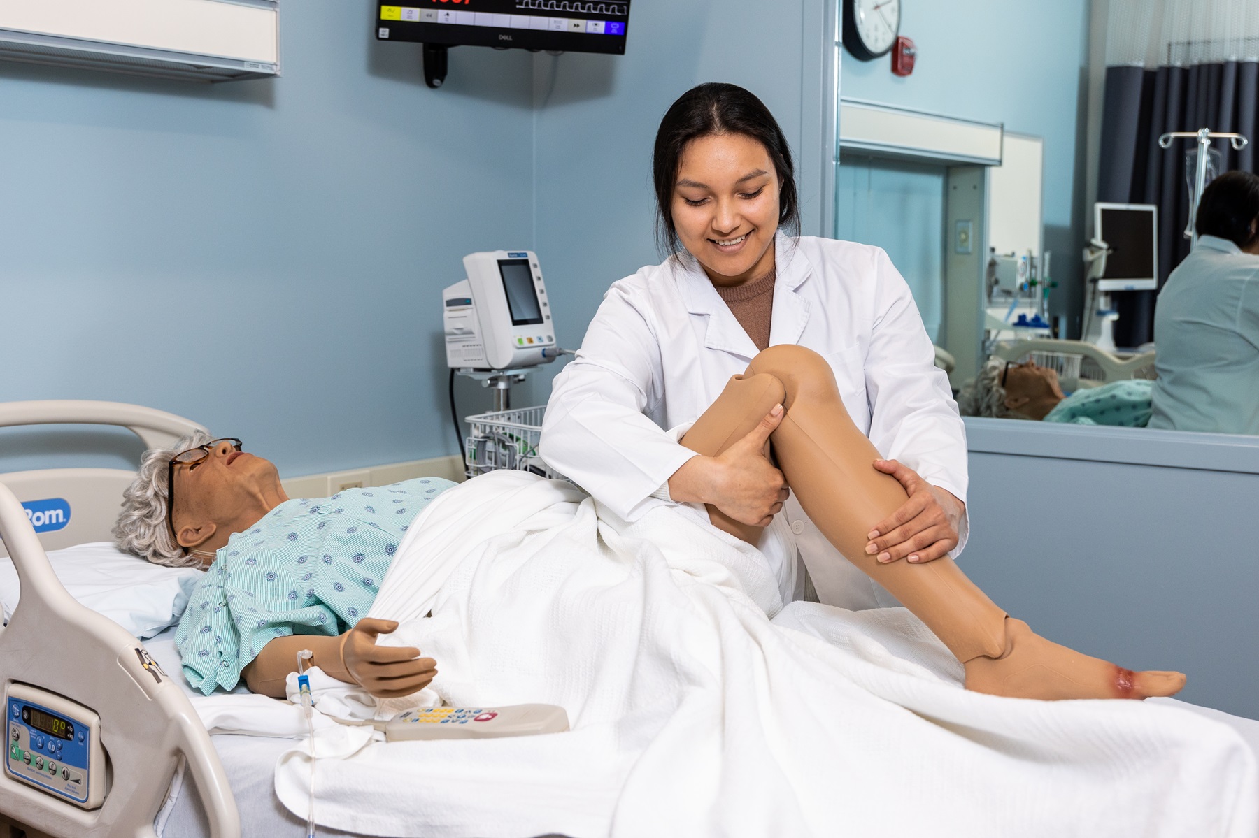 A student interacts with a patient simulator