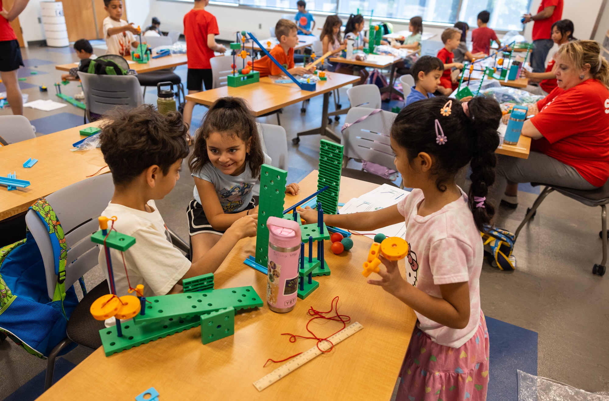Young students interact with gears during an InZone class on Harper's campus