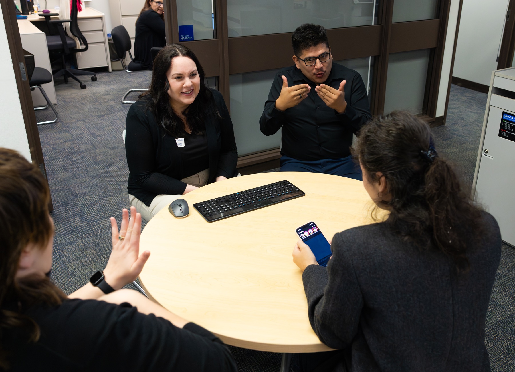 Job Placement Resource Center A student, a Harper College employee and two interpreters communicate at a table in Harper's Job Placement Resource Center.