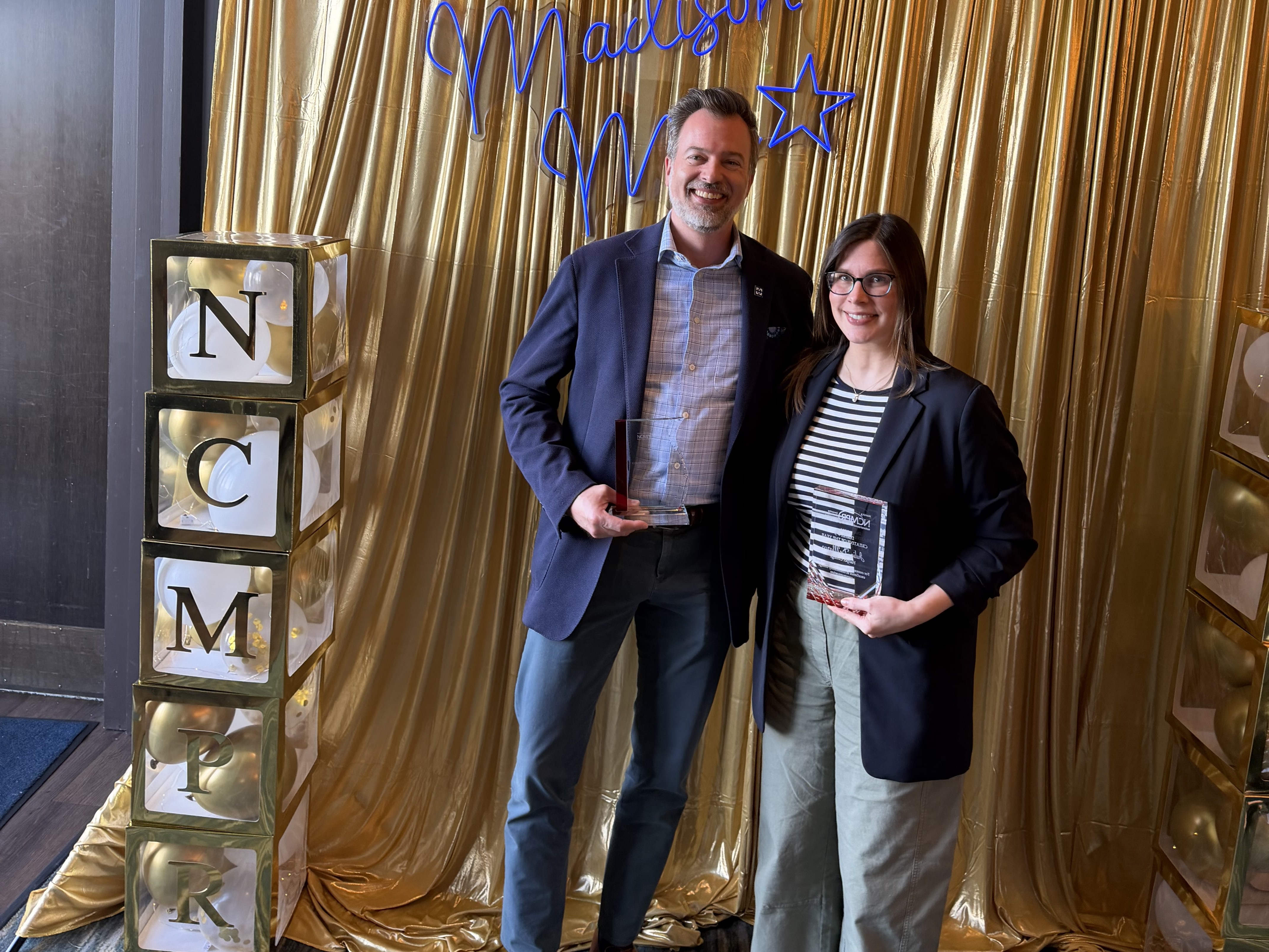 Jeff Julian and Julie DeMarco hold their NCMPR awards