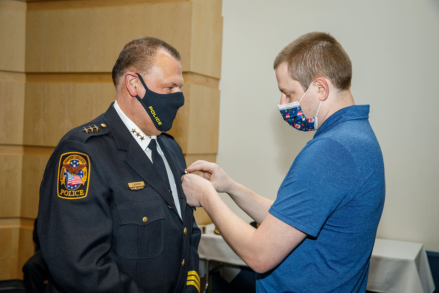 Police Chief John Lawson has badge pinned on by son