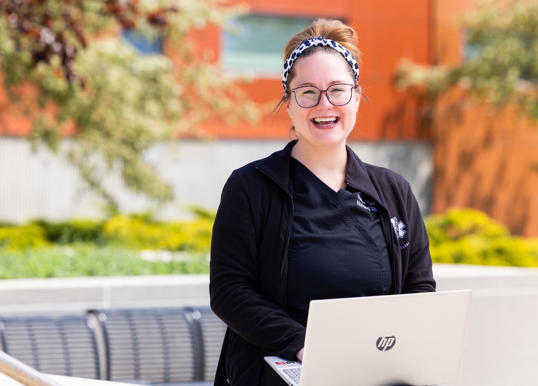 Karissa Olsen works on her laptop on Harper's campus.