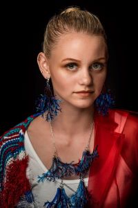 A model wears jewelry designed in the Makerspace by Harper student Yesenia Guzman